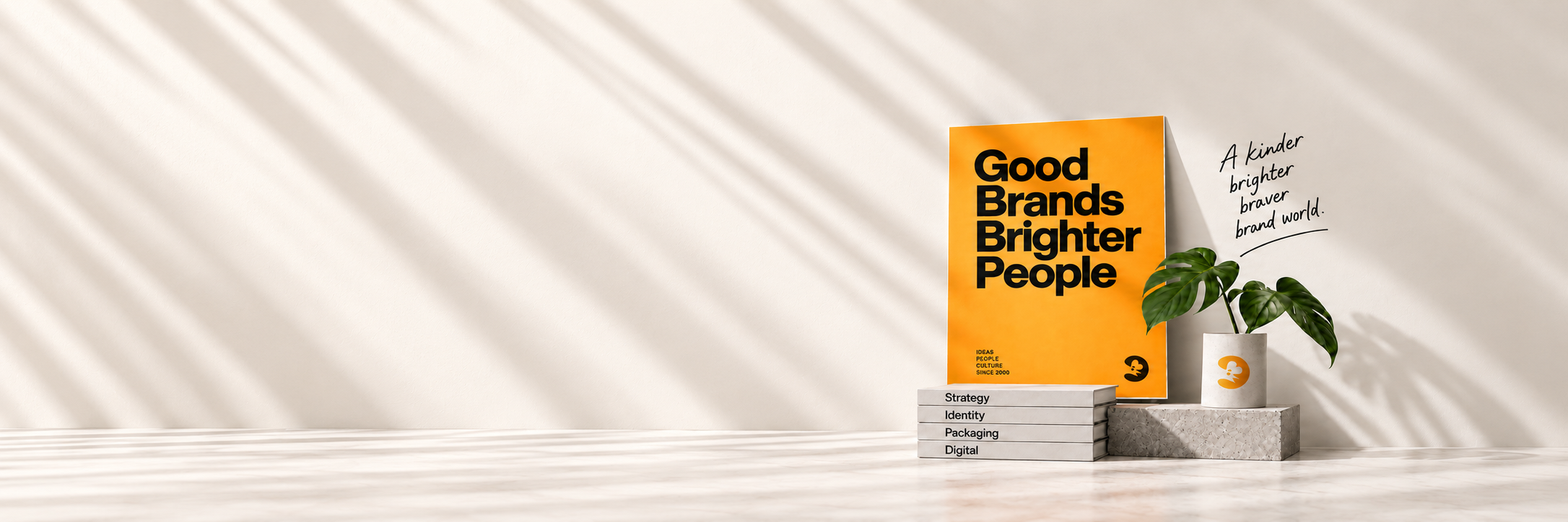 Brenda identity still life: golden orange Good Brands Brighter People poster, original Brenda emblem and orange emblem-only planter