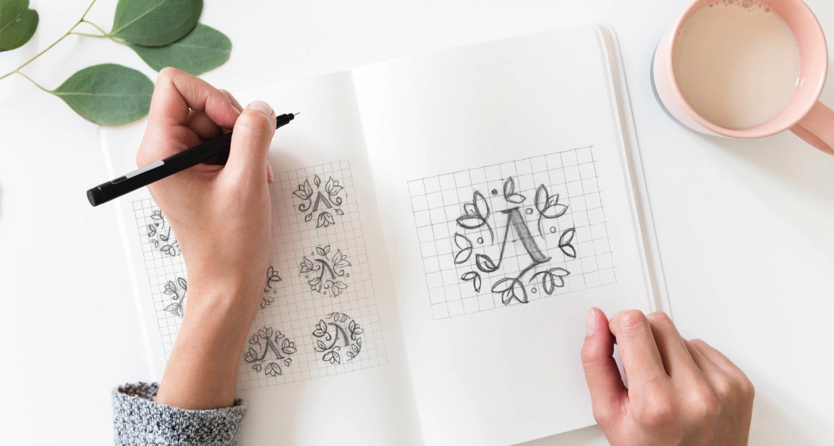 Open sketchbook with original Listva botanical monogram drawings